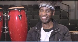 A man with a mohawk and a black jacket