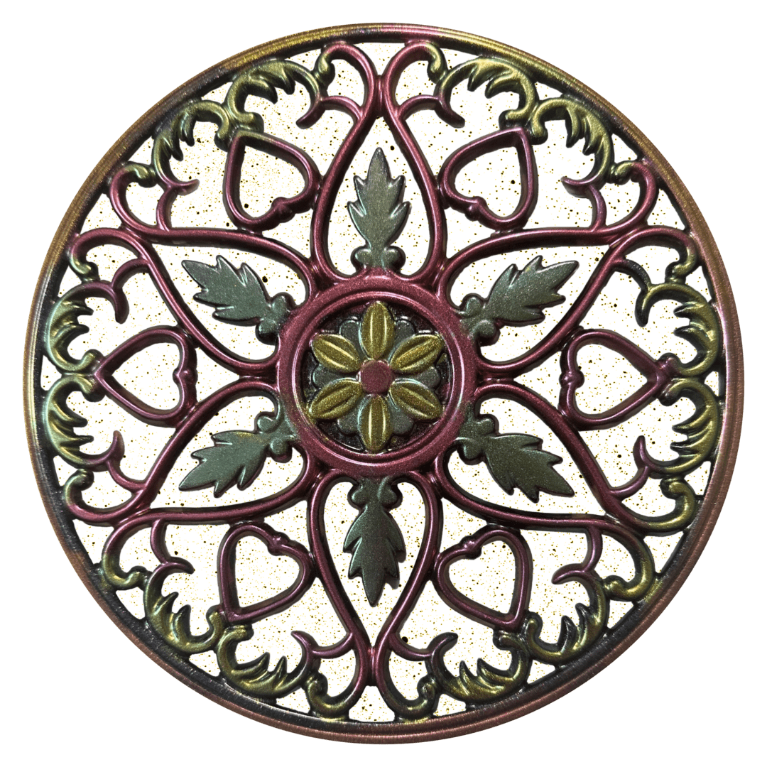 A round decorative metal work piece with green and red designs.